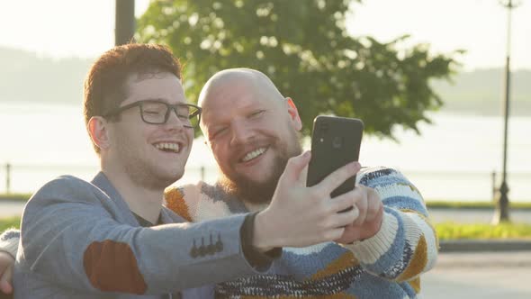 Men Taking Selfie on Smartphone Dating at Sunrise. Cute Male Homosexual Gay Couple Spend Time alt