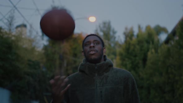 Authentic Black Man Walk at Dusk with Basketball alt