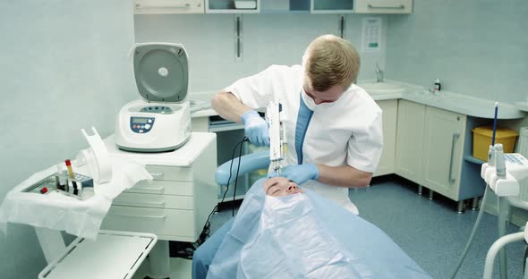 In a Modern Clinic Room Doctor Make a Facial Procedure alt