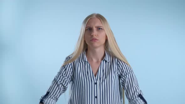 Restless Young Woman Showing Negative Feelings and Giving Thumbs Down alt