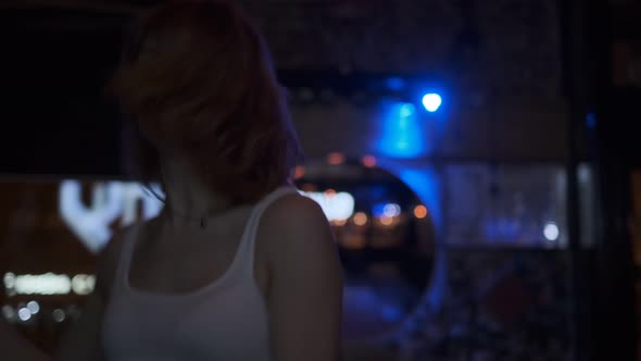 Carefree Crazy Girl Dancing on the Dance Floor in a Nightclub alt