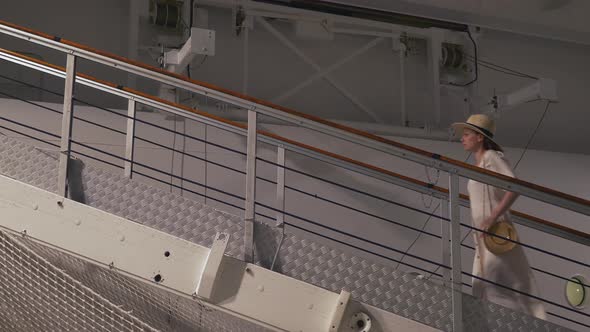 Young girl climbing the stairs to the ship alt