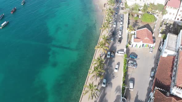 Aerial Stone Town Embankment with Palms Seaport with Boats in Ocean Zanzibar alt