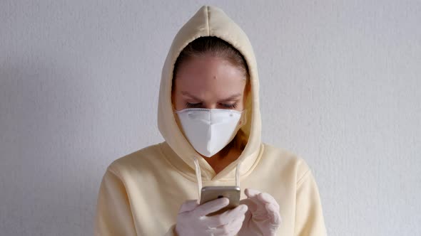 Woman Wearing Protective Mask Using Mobile Phone Isolate on a White Background alt