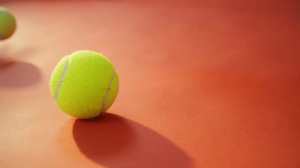 Tennis ball bouncing on red floor 4k alt