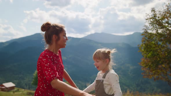 Mother Spinning Daughter Dance Summer Holiday Close Up alt