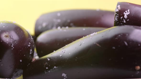 Ripe eggplant on a yellow background alt