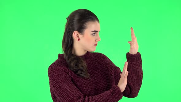 Woman Strictly Gesturing with Hands Shape Meaning Denial Saying NO. Green Screen alt