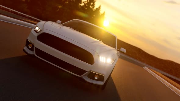 White Sports Car Shooting From Front While Driving On Asphalt Road At Sunset
