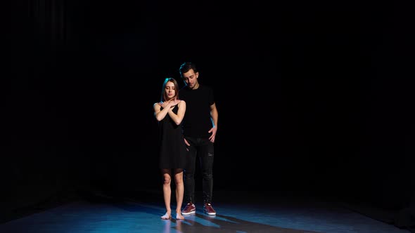 Romantic Choreography Against Black Background in Spotlight at Studio alt