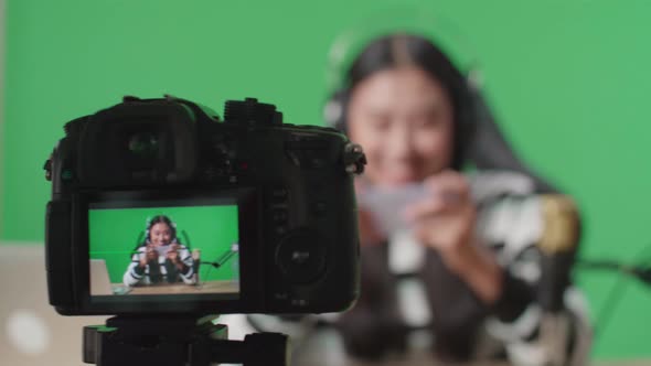 Camera Monitor Recording Asian Woman Gamer Using Mobile Phone Playing Game On The Green Screen alt