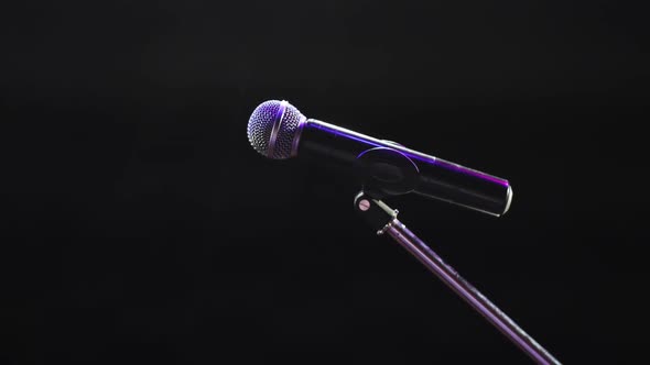Concert Microphone on Stage for Record or Speak To Audience on Dark Background.