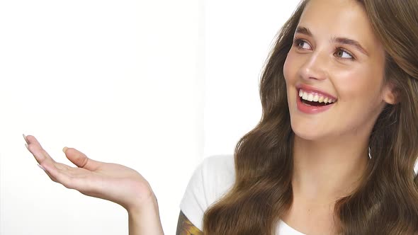 Lovely Girl Holding Empty Space in Her Arm with Cute Smile and Perfect Wavy Hair alt