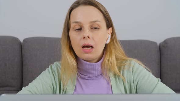 Freelancer speaking with customer on web camera in laptop computer in 4k video alt