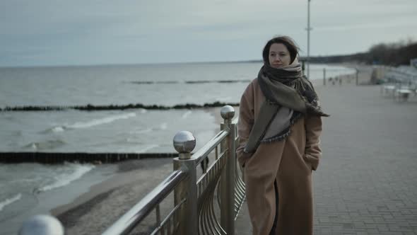Young Woman Walking Along The Beach alt