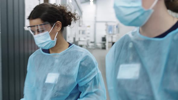 Two Female Doctors Walking Through Hospital alt