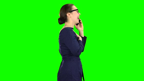 Woman Is Going To a Meeting and Talking on the Phone. Green Screen. Side View alt