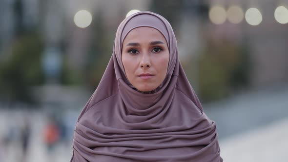 Close Up Sad Upset Muslim Woman Beautiful Young Islamic Girl Arabian Lady in Hijab Stands in City alt