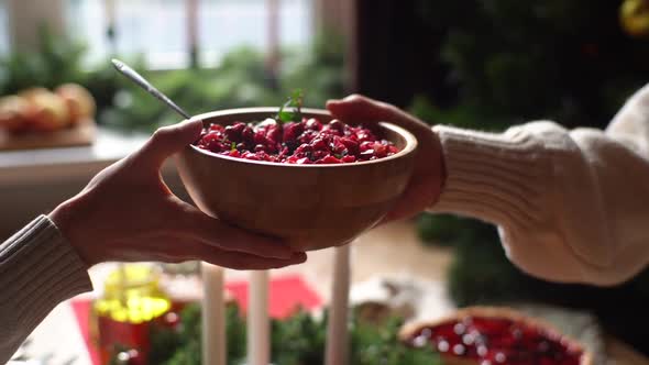 Closeup Hands of Unrecognizable Young Woman and Man Passing Delicious Food Sitting at Festive alt