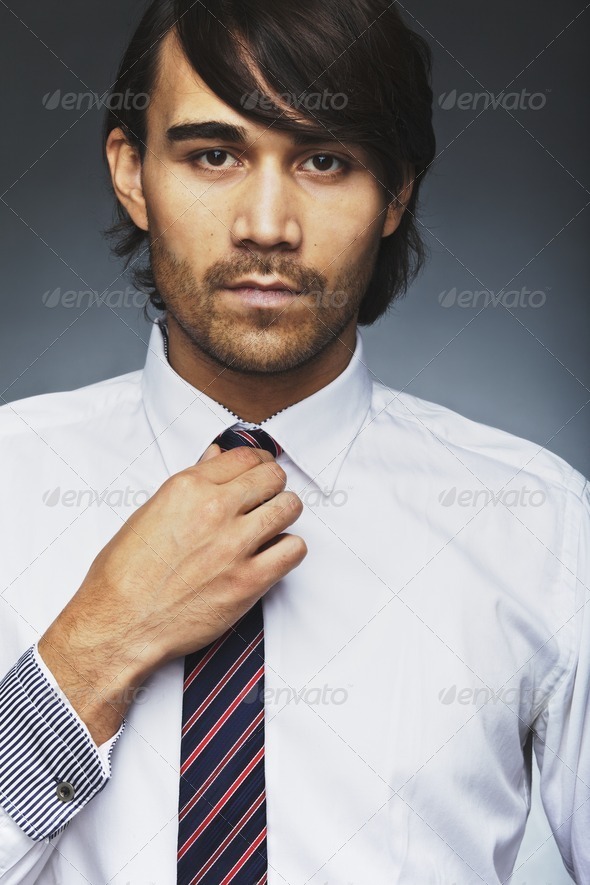 Handsome business executive wearing tie - Stock Photo - Images