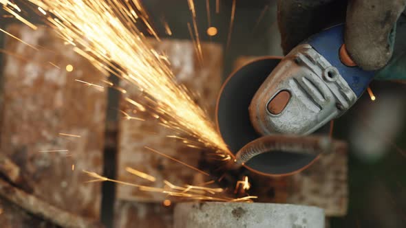 Foreman in Protective Gloves Using Grinder Cutting Metal Tube