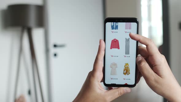 Young Woman Using Smartphone Shopping Online Buying Clothes Browsing Internet Online Store in Mobile alt