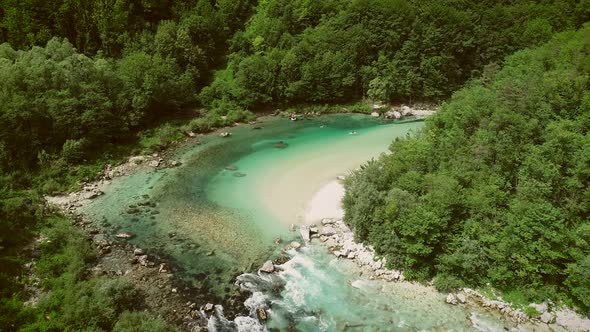Aerial view of a group doing water rafting on the rapids at Soca River. alt