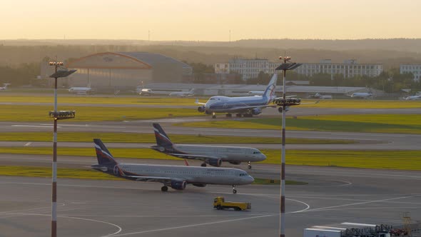 Driving planes in Sheremetyevo Airport at sunset, Moscow alt