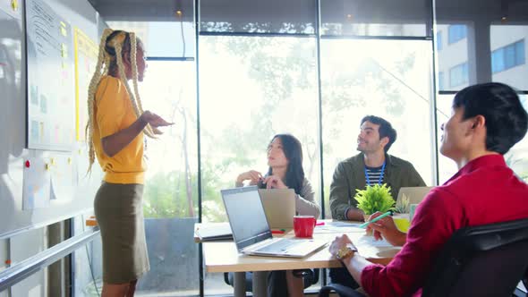 brainstorming about mobile app interface workflow design on table with coworke alt