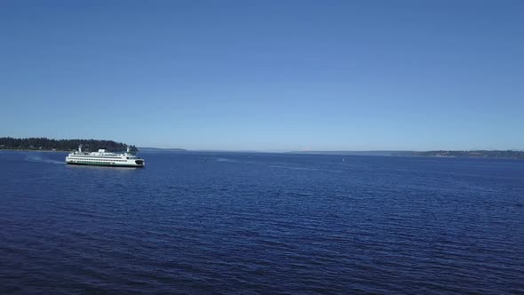 Aerial view of the Seattle Ferry following the route Seattle and Bainbridge Island. alt