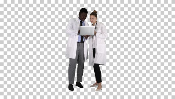 Medical staff working in front of a grey laptop while standing alt