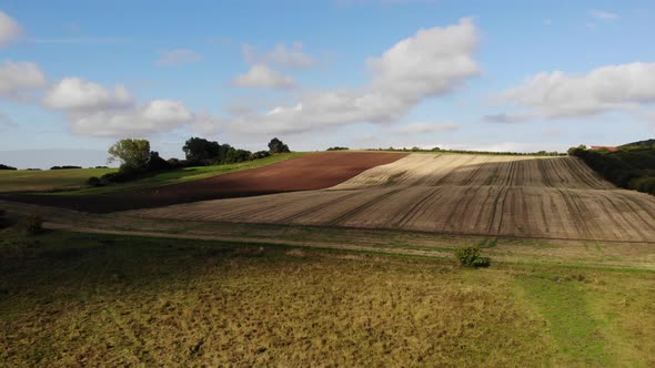 Aerial view of golden fields with brown mold close to Sejerøbugten in Odsherred. alt