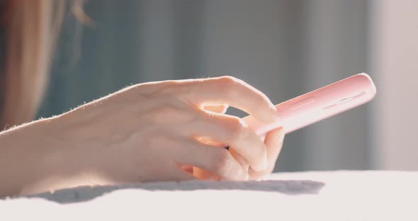 Hand of Girl Using Smartphone at Bedroom at Home Typing Message alt