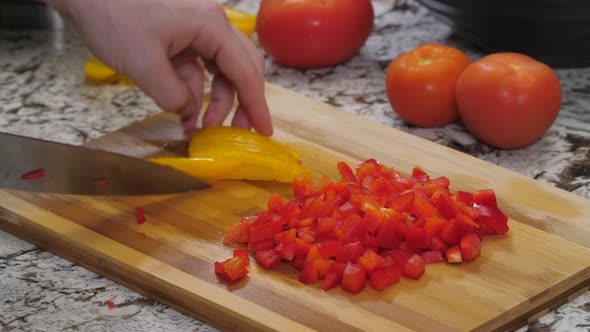 Dicing Yellow And Red Peppers On Kitchen Wood Cutting Board 01