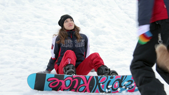 Girl Snowboarder Lying in the Snow