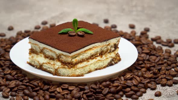 Portion of Traditional Italian Tiramisu dessert and coffee beans alt
