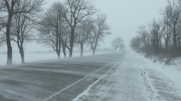 Cars on Winter Road at Blizzard alt