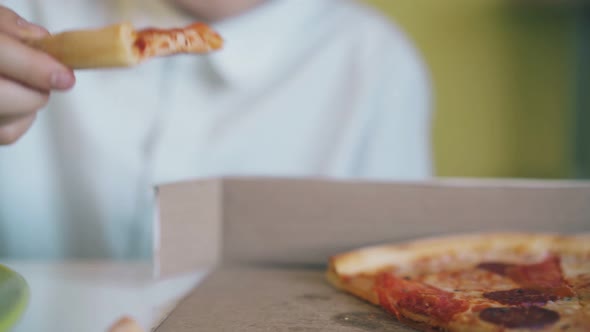 Schoolboy Takes Pizza From Box at Dinner in Room Closeup alt