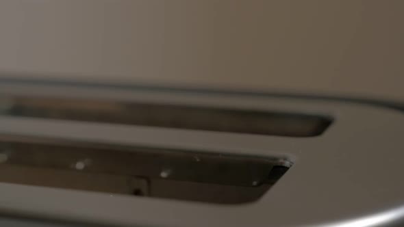 Roasted bread popping up from toaster machine slow motion 1080p FullHD footage - Toasting bread in m alt