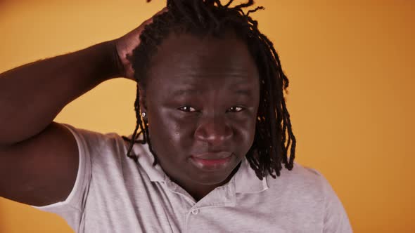 Portrait of Young Happy African American Black Man Stroking His Braided Hair alt