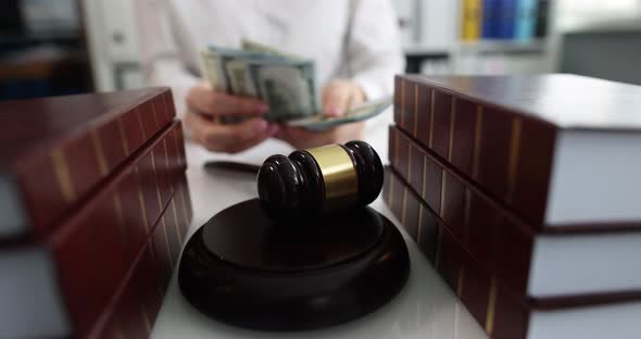 Judge Counting Money in Front of Gavel and Court Case Documents  Movie alt