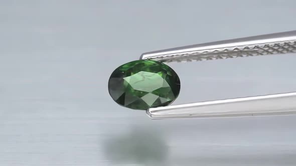 Natural Green Chrome Tourmaline in the Tweezers on the Turn Table
