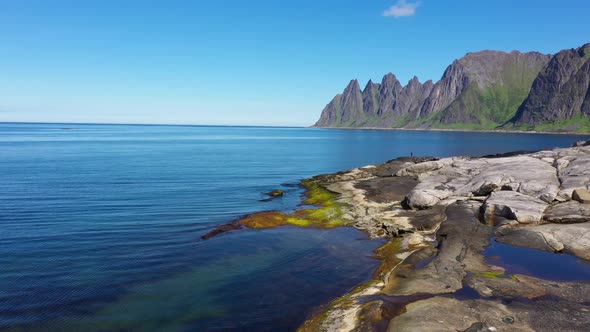 View on popular travel destination and Rock Davil’s Jaw in the sunny summer day, Norway,island Senja