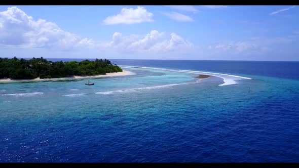 Aerial flying over landscape of beautiful shore beach time by shallow water with white sand backgrou alt