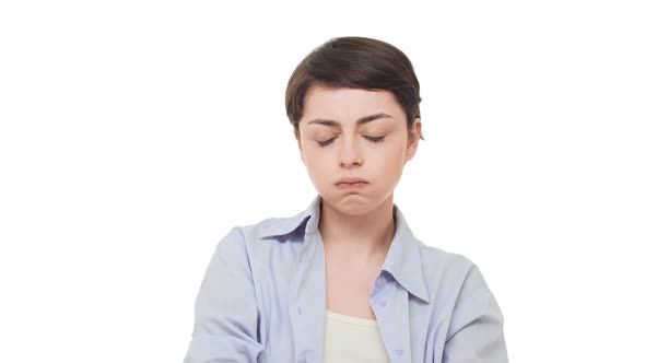 Concentrated Young Beautiful Caucasian Female Sighing Heavily Over White Background and Slowly alt
