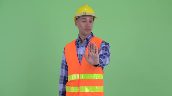 Serious Multi Ethnic Man Construction Worker with Stop Gesture alt