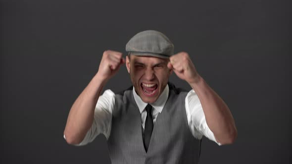 Portrait of Screaming Oldfashioned Guy in English Style Rejoicing His Triumph with Clenching Fists alt