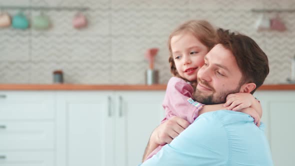 Tenderly embracing father and daughter. Young father hugging little daughter alt