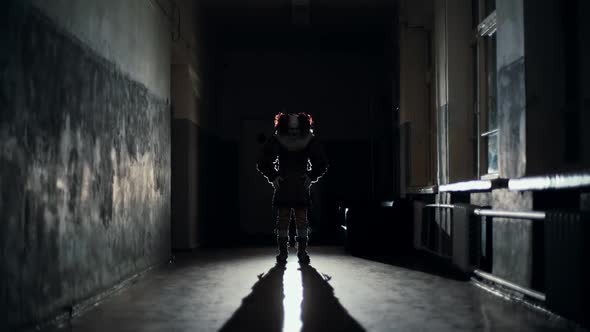 Scary Clown in a Dark Corridor at Night Scares a Man in Slow Motion alt