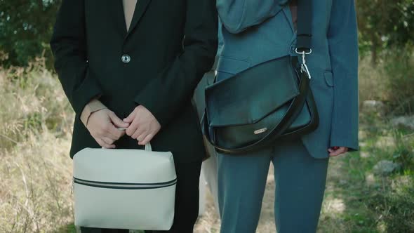 Two modelses away discovering a beautiful black woman pose for the camera wearing trendy suit and ba alt